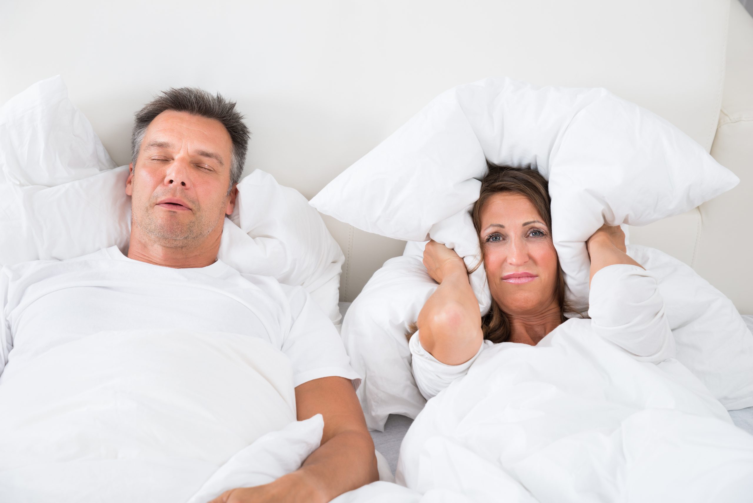 Angry Woman Trying To Sleep With Snoring Man